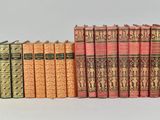 the books are lined up in a row on the table