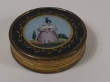 a small box with a picture of a woman in a pink dress