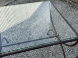 a glass table with a metal frame and a glass top