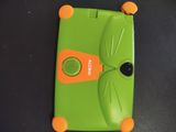 a green and orange cell phone sitting on a table