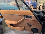 a car door with the door handle open and the door handle down