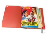 a red book with a picture of two girls and a boy on it