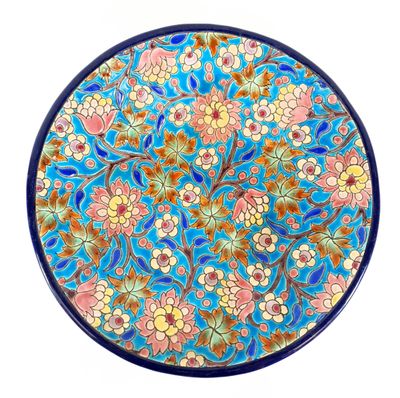 a close up of a blue plate with flowers on it