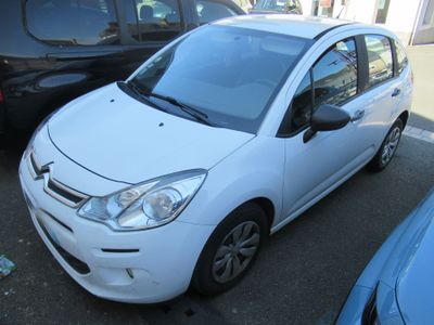 a picture of a small white car parked in a parking lot