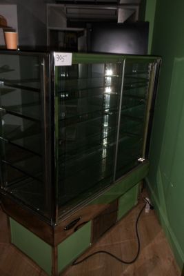 a glass display case in the corner of a room