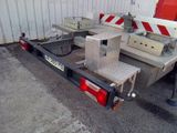 an image of a flatbed trailer parked in front of a building