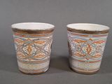 two cups sitting next to each other on a table