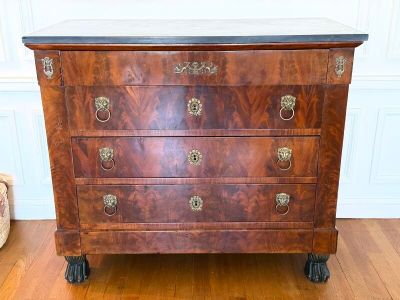 a small chest of drawers on wheels in a room