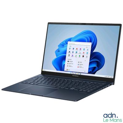 a close up of a laptop computer on a white surface