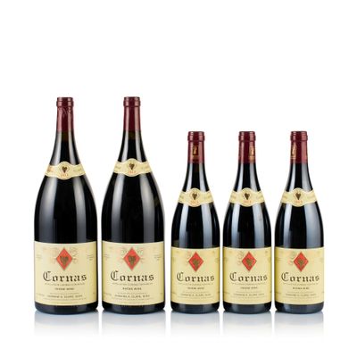 four bottles of red wine are lined up in a row