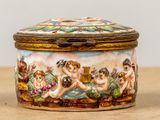 a small box with a painting on it sitting on a table