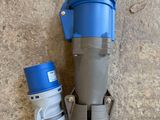 an overhead view of a blue and grey water meter and a blue and white water meter on the ground