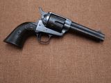a close up of a revolver on a brown background