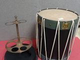a drum and a stand on a red table