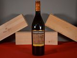 a bottle of wine sitting on a table next to two wooden boxes