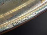 an image of a close up of a silver plate on a table