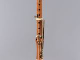 an orange and white flute on a clear stand
