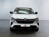 the front view of a white car in a white room