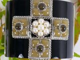 an image of a bracelet with pearls and a cross on it