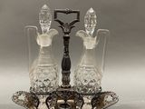a silver plate with two crystal decanters on it
