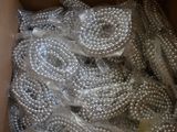 a box full of silver beads in it on a table