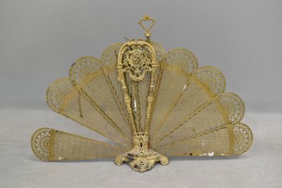 brass plated fan with intricate design on top of it