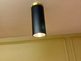 a lamp that is on the ceiling above a mannequin