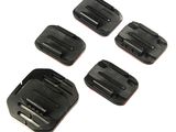 four pieces of black plastic buckles on a white surface