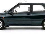 a small black car that is parked on a white surface