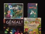 several board games are sitting on a black surface with a black background