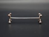 a close up of a metal bar with two balls on it