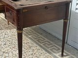 a wooden table with a drawer on it on a tiled floor