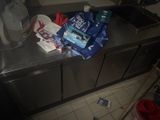 a metal counter with a bunch of items on top of it