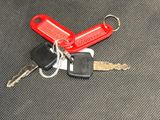a red keychain with two keys attached to it