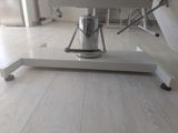 a white table with a coffee pot on top of it