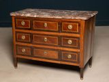 a marble top chest of drawers on a stand