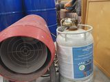 a red barrel and a blue barrel sitting next to each other in a warehouse