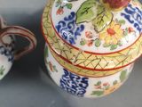 two cups and a saucer sitting on a table