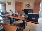 a desk with a computer and a chair in the room