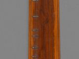 a wooden ruler that is on a gray surface