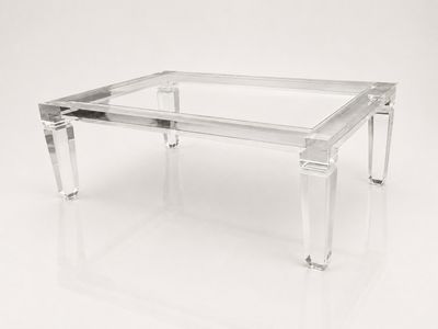 a clear glass coffee table with clear legs and a clear glass top