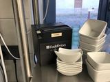 many bowls and plates on the shelf in the kitchen