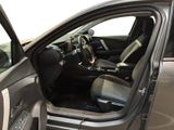 the interior of a car with the door open and the driver ' s seat down