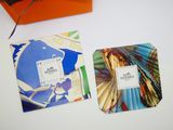 two square coasters that have different designs on them