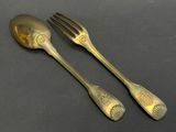 two forks and spoons sitting next to each other on a table