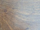 a close up of a wooden table with a clock on it