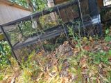 a fence that has a bench in the middle of it