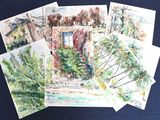several watercolor paintings of palm trees and buildings on a blue surface