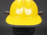 a yellow hard hat sitting on top of a black base