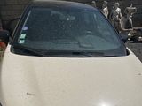 a picture of a dirty car parked on the side of the road